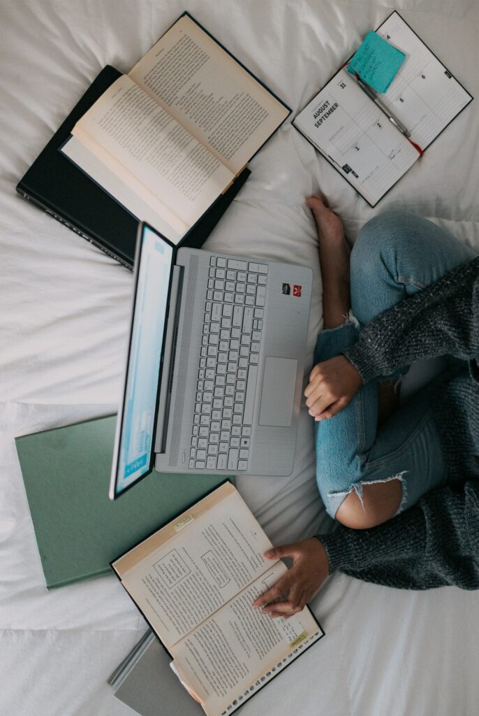 person in gray sweater working on computer